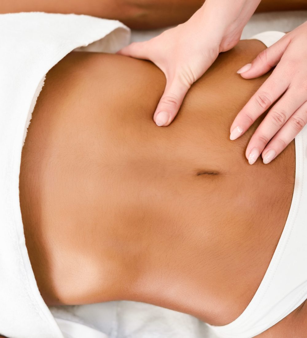 Woman receiving abdomen massage in spa wellness center. Beauty and Aesthetic concepts.